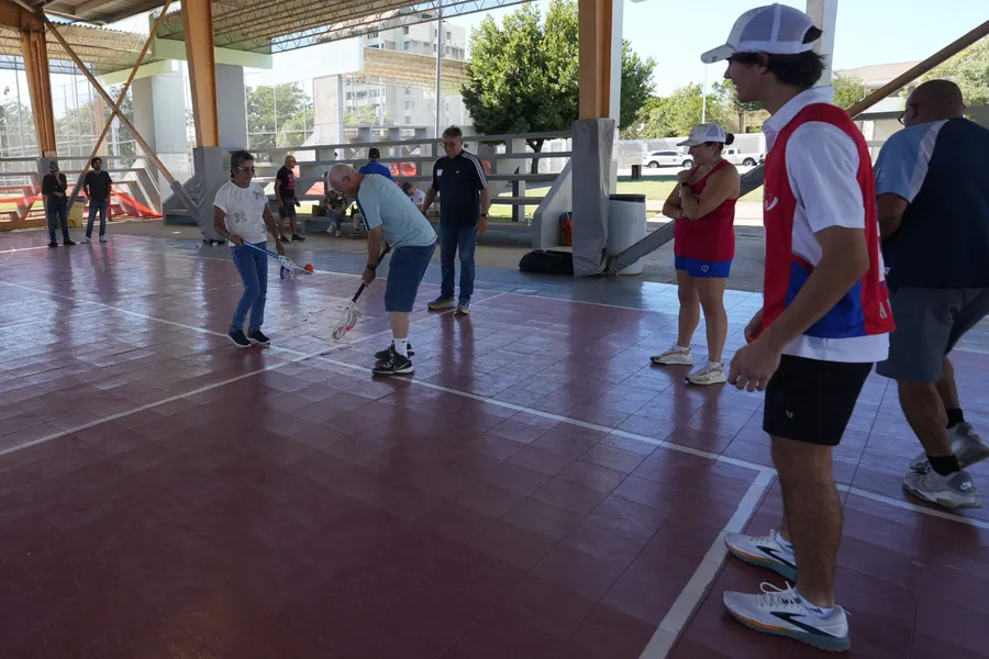 Community members trying lacrosse